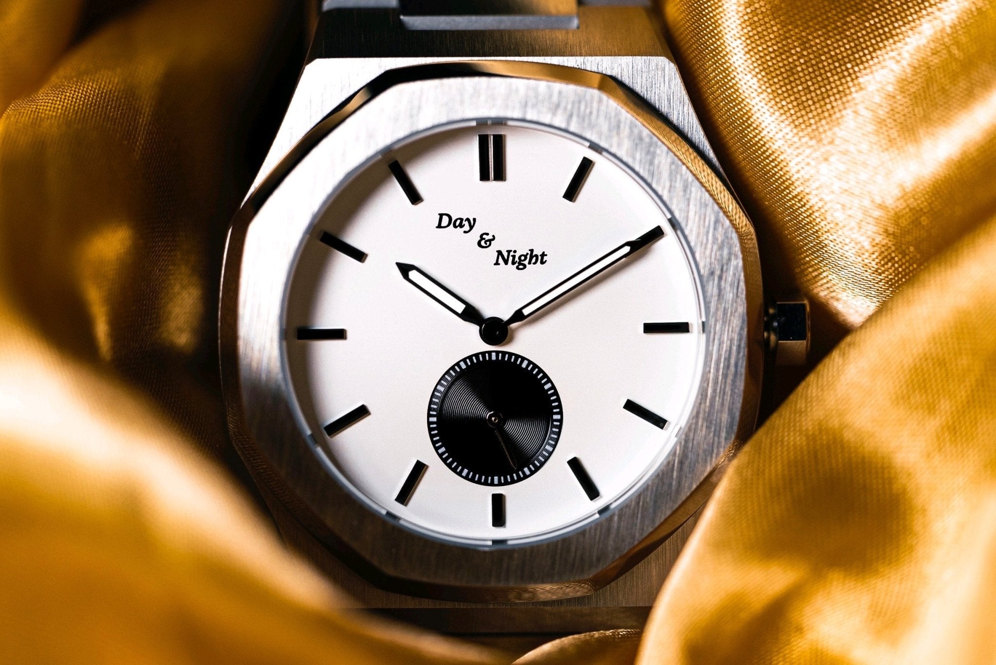 Day and Night watch displayed next to laptop representing online shopping